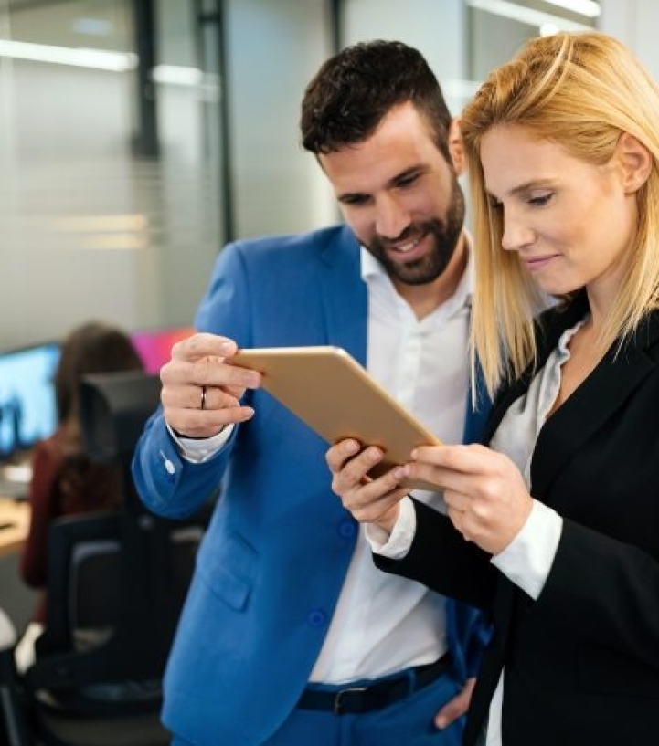 businesspeople-discussing-while-using-digital-WFGVC3X@2x.jpg